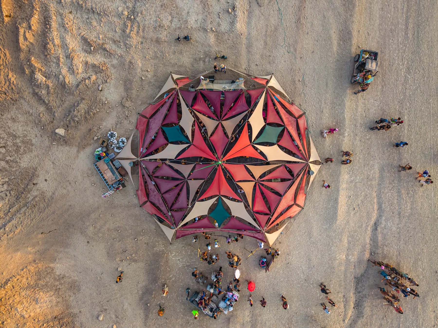 Overhead view of a geometric shade canopy in red, purple and white.